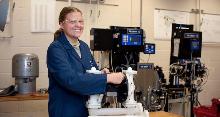 female industrial building engineer providing maintenance to equipment in lab