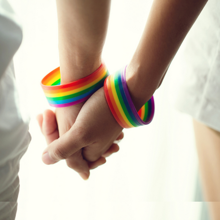 holding hands with rainbow bracelet